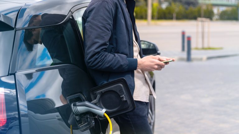 Man charging electric car